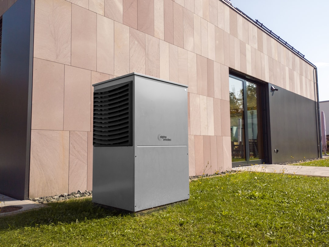 modern air-source heat pump installed outside a residential home in winter - how a heat pump heats and cools your home