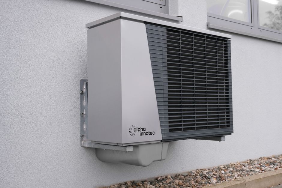 modern high-efficiency AC unit outside a suburban home in summer